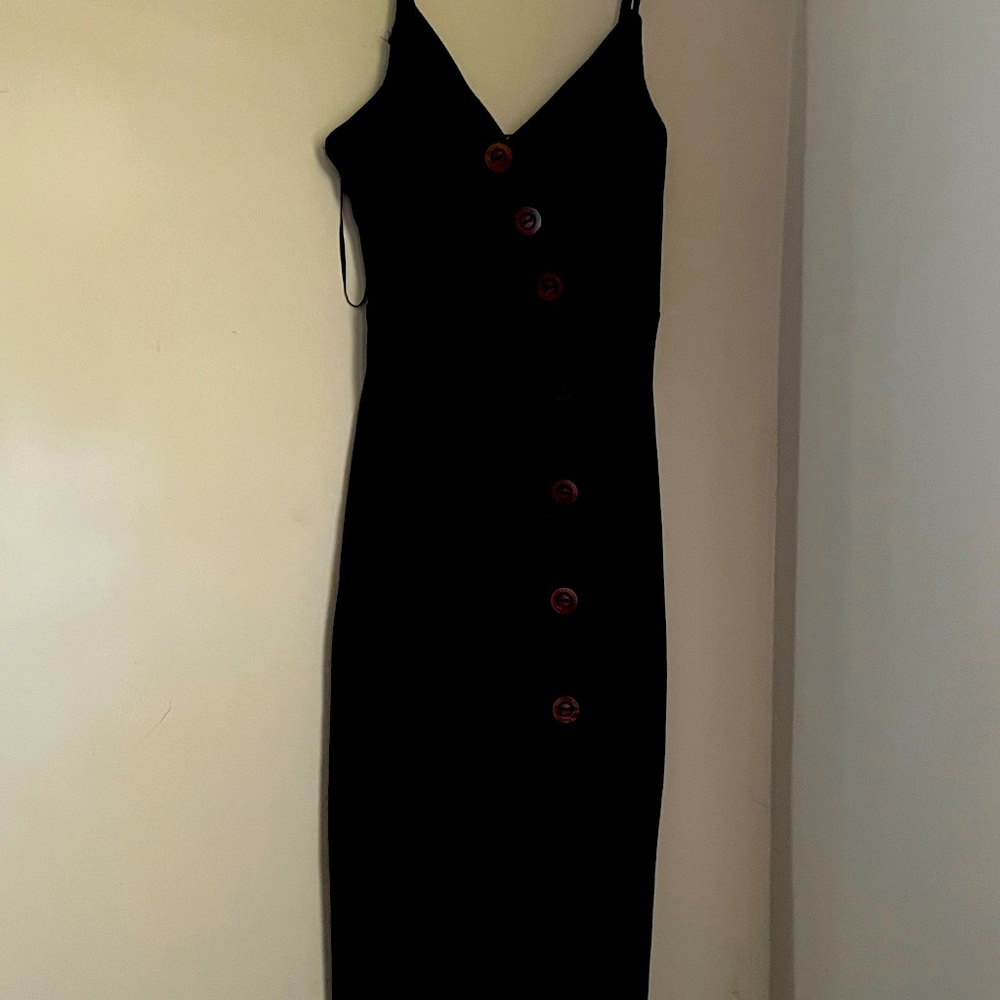Black spaghetti strap dress with brown button and high split